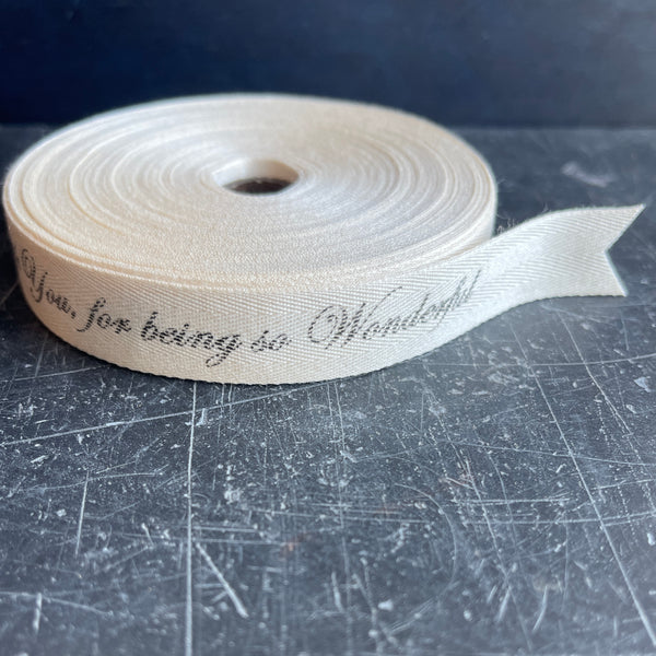 16mm herringbone cotton with personalised message of your choice, cream with a charcoal font in a script font 