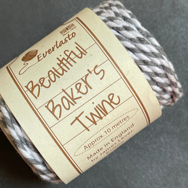 Roll of Baker's Twine with a label on a gray background