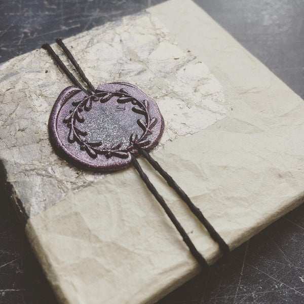 wax seal on  a wrapped gift