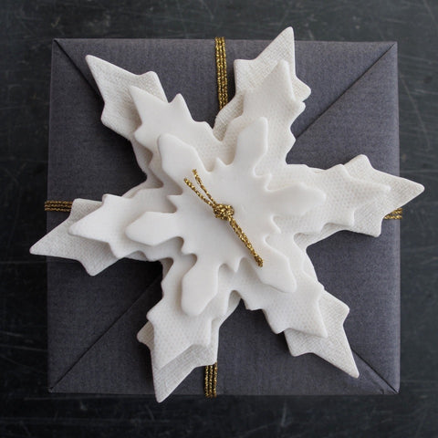 Porcelain snowflakes stacked to create a beautiful  gift wrapping detail detail