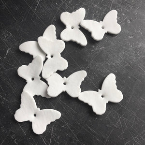 White Porcelain wedding favours in the shape of butterflies 