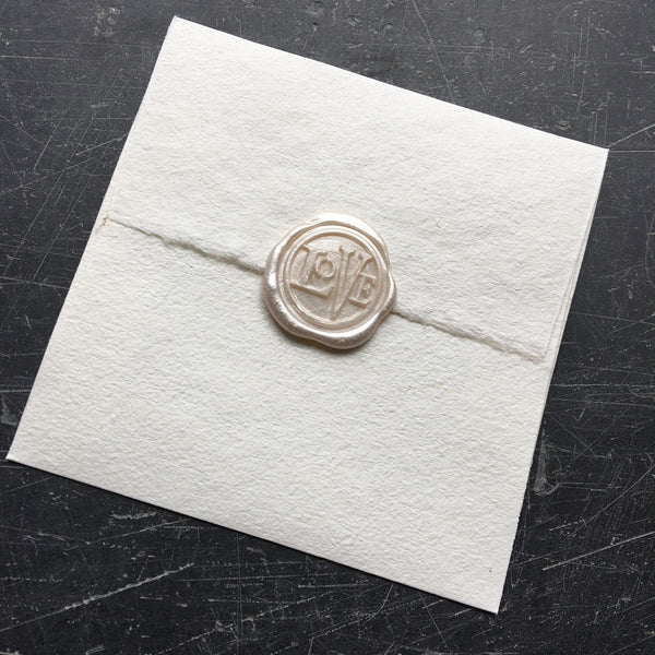 wax seal adornment on letter, sealed with love